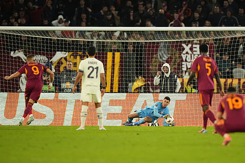 Lille goalkeeper Berke Özer saves a penalty kicked by Roma's Artem Dovbyk during the Europa League Europa League soccer match between AS Roma and Lille at the Olympic stadium in Rome, Thursday, Oct. 2, 2025.