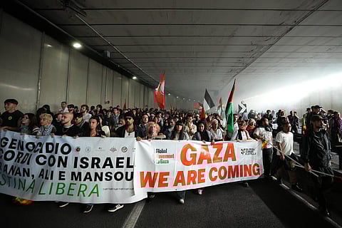 Pro-Palestinian demonstrators march along the Rome’s ring road as they gather for a national general strike called by different unions to protest against the situation in Gaza two days after Israeli forces intercepted a Gaza-bound aid flotilla in the Mediterranean Sea, in Rome, on Friday, Oct. 3, 2025. 