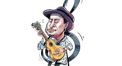 A fan holds a photograph of the popular Bollywood singer and composer Zubeen Garg during the homage ceremony in Guwahati, Sunday, Sept. 21, 2025