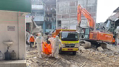 Rescuers carry the body of a newly recovered victim of a building that collapsed at an Islamic boarding school in Sidoarjo, East Java, Indonesia, Sunday, Oct. 5, 2025. 