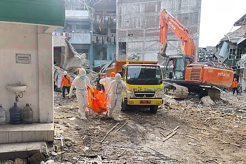 In this photo released by the Indonesian National Search and Rescue Agency (BASARNAS) on Monday, October. 6, 2025, rescuers remove the body of a victim from the rubble of a collapsed building at an Islamic boarding school in Sidoarjo, East Java, Indonesia
