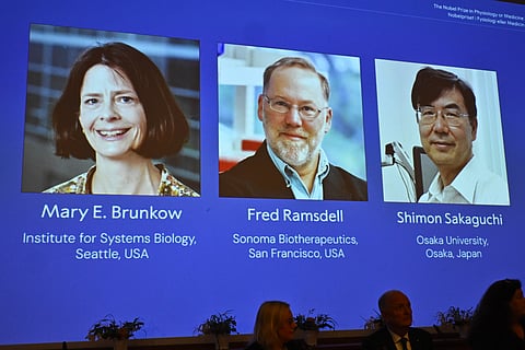 A screen showing the photos of Mary E Brunkow, Fred Ramsdell and Shimon Sakaguchi who were awarded the Nobel Prize in Medicine or Physiology, at the Nobel Assembly of the Karolinska Institutet, in Stockholm, Sweden, Monday, Oct. 6, 2025.