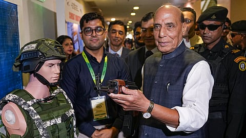 Defence Minister Rajnath Singh holds a rifle during the inauguration of a national-level conference on 'Opportunities of Defence Manufacturing in the country', at Vigyan Bhawan, New Delhi