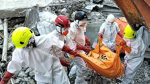 In this photo released by the Indonesian National Search and Rescue Agency (BASARNAS) on Monday, October. 6, 2025, rescuers remove the body of a victim from the rubble of a collapsed building at an Islamic boarding school in Sidoarjo, East Java, Indonesia