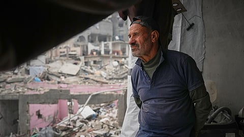 Khaled Nassar looks over the destruction at his apartment in the Jabaliya refugee camp in Gaza City Feb. 9, 2025. Nassar's daughter, Dalia, and his son, Mahmoud, were killed in separate airstrikes, leaving both buried under their homes.