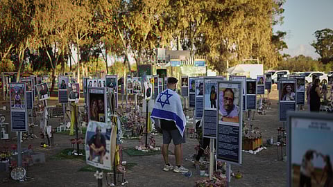 People visit the site of the Nova music festival, where hundreds of revelers were killed and abducted by Hamas and taken into Gaza, as Israel marks the second year anniversary of the attack, near Kibbutz Reim, southern Israel, Tuesday, Oct. 7, 2025.