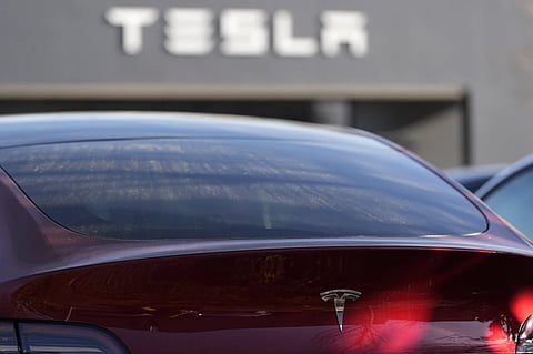 A Tesla model Y and other Telsla vehicles sit at a dealership, Wednesday, March 19, 2025, in Kennesaw, Ga. 