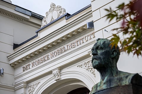 Activists carry signs during a protest against President Donald Trump's federal takeover of policing of the District of Columbia, Saturday, Aug. 16, 2025, in Washington.