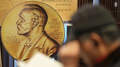 A visitor reads a book written by South Korean author Han Kang, this year's winner of the Nobel Prize in Literature, at a special section of a bookstore in Seoul, South Korea, Tuesday, Dec. 10, 2024.