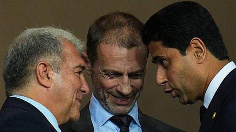 UEFA President Aleksander Ceferin, center, FC Barcelona president Joan Laporta, left, and PSG president Nasser Al-Khelaifi speak before the Champions League opening phase football match between Barcelona and Paris Saint-Germain at the Lluis Companys Olympic Stadium in Barcelona, Spain, Wednesday, Oct.1, 2025.