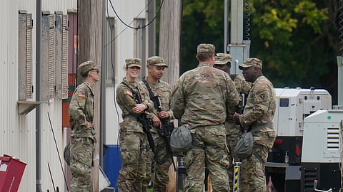 Military personnel in uniform, with the Texas National Guard patch on, are seen at the U.S. Army Reserve Center, Tuesday, Oct. 7, 2025, in Elwood, Ill., a suburb of Chicago.