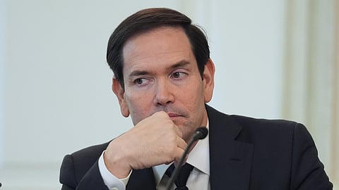 Secretary of State Marco Rubio listens before interrupting President Donald Trump during a roundtable meeting on antifa in the State Dining Room at the White House, Wednesday, Oct. 8, 2025, in Washington.