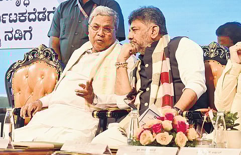 CM Siddaramaiah in conversation with Deputy CM DK Shivakumar at a programme to launch ‘Neeriddre Nale’ initiative in Bengaluru on Thursday. 