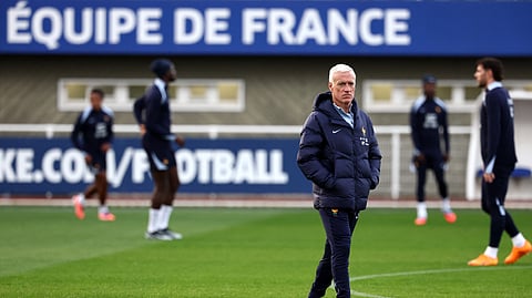 France's head coach Didier Deschamps walks on the pitch during a training session as part of preparations for upcoming FIFA World Cup 2026 Group D European qualification football matches at the team's training grounds in Clairefontaine-en-Yvelines, southwest of Paris, on October 8, 2025.