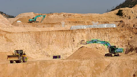 Workers use machinery to dig at a rare earth mine in Ganxian county in central China's Jiangxi province on Dec. 30, 2010.