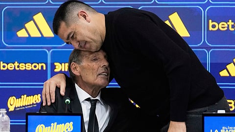 Boca Juniors President Juan Riquelme, right, embraces new head coach Miguel Angel Russo during his first press conference in Buenos Aires, Argentina, June 2, 2025.