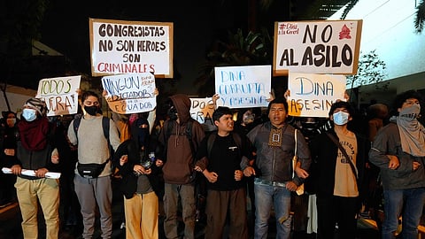 Opponents of Peruvian President Dina Boluarte protest outside of the Ecuadorian Embassy in Lima, Peru, Thursday, Oct. 9, 2025.