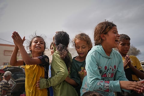 Displaced Palestinians walk along the coastal road near Wadi Gaza in the central Gaza Strip, moving toward northern Gaza, Friday, Oct. 10, 2025, after Israel and Hamas have agreed to a pause in their war and the release of the remaining hostages.