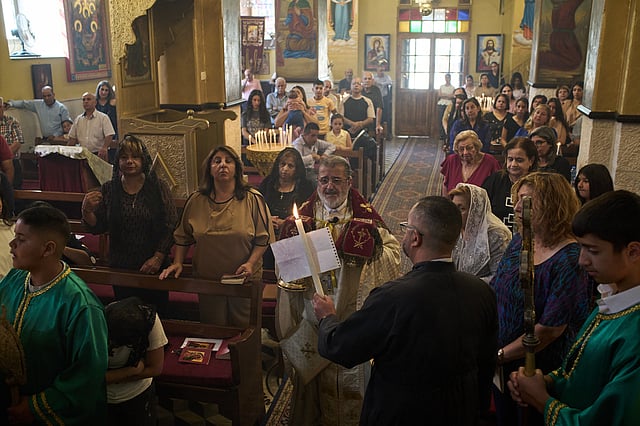 Greek Orthodox parish priest David Khoury attends morning Mass at St. George Church in the West Bank village of Taybeh, Sept. 28, 2025.