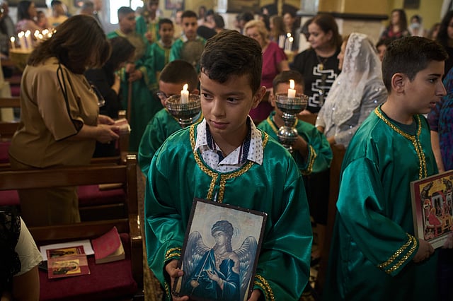 Palestinian children attend morning Mass at the Greek Orthodox Church of St. George in the West Bank village of Taybeh, Sept. 28, 2025.