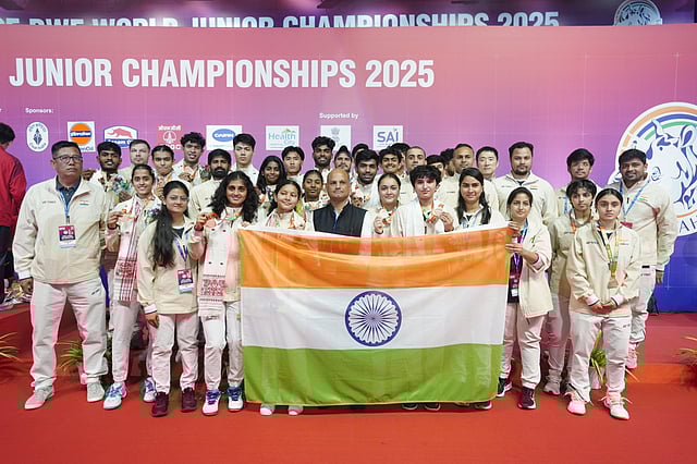 Indian shuttlers and support staff members with BAI  general secretary Sanjay Mishra (centre) on Saturday. This was India's first-ever medal (bronze) in the mixed team competition of the championships