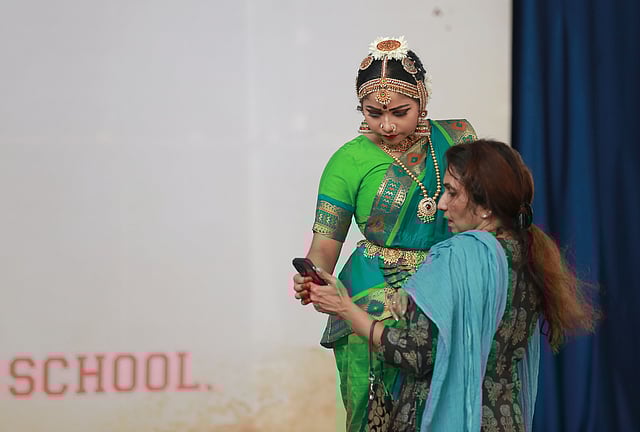A student shares a light moment with her mother