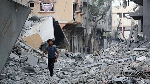A Palestinian youth looks at destroyed buildings in Jabalia in the northern Gaza Strip on October 12, 2025.