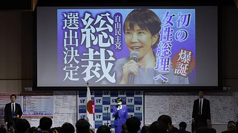 In this Oct. 4, 2025, image, newly elected leader of the Liberal Democratic Party (LDP) Sanae Takaichi, center, speaks during a gathering after the LDP's leadership election in Tokyo. The words read, "Toward the first female prime minister. Selected as the LDP's leader." 