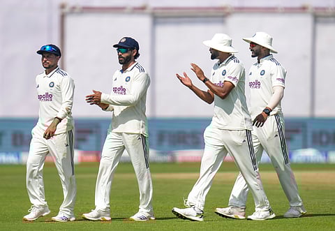 Kuldeep Yadav, left, being greeted by teammates after taking a five-wicket haul on day three.