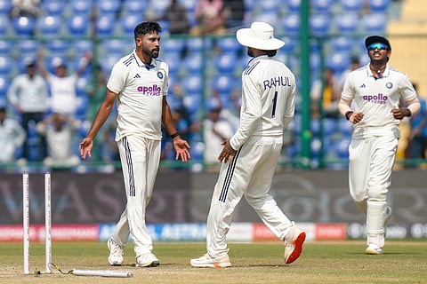 Mohammed Siraj celebrates with teammate KL Rahul after taking the wicket of West Indies' Shai Hope during the fourth day of the second and final Test between India and West Indies at the Arun Jaitley Stadium in New Delhi (Photo | PTI)