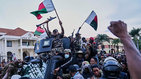 Soldiers are greeted by people gathering for a ceremony in tribute to demonstrators killed during recent anti-government protest in Antananarivo, Madagascar, Sunday, Oct. 12, 2025.