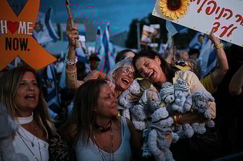 People gather prior to the release of Israeli hostages held in Gaza, at a plaza known as the hostages square in Tel Aviv, Israel, Monday, Oct. 13, 2025
