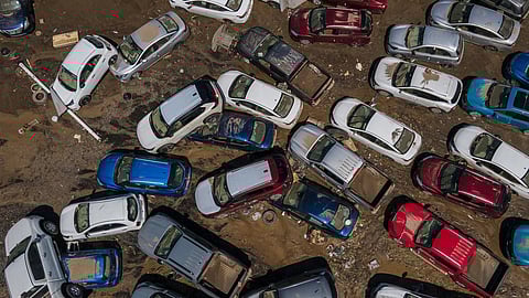 Damaged vehicles sit in mud after flooding in Poza Rica, Veracruz state, Mexico, Sunday, Oct. 12, 2025.