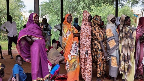 Women wait for cash assistance and dry grain from the U.N. World Food Programme in Gendrassa refugee camp, Maban, South Sudan, Wednesday, Aug. 20, 2025.