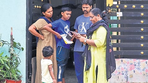 An enumerator collects details from a family during the socio-economic survey in Horamavu.