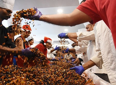 People participating with the traditional cake mixing ceremony at a Chennai hotel