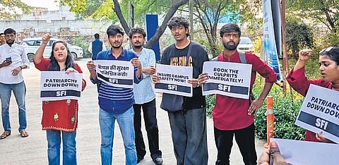 SFI members protest outside varsity, carrying placards and shouting slogans