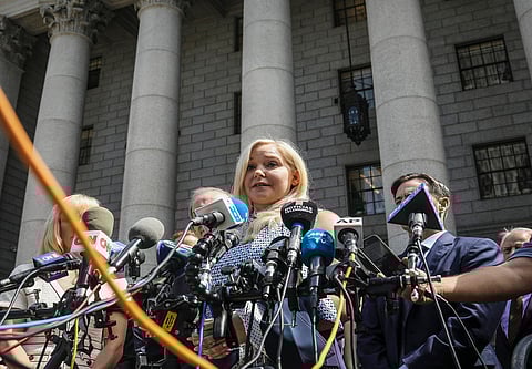 Virginia Roberts Giuffre, center, who says she was trafficked by sex offender Jeffrey Epstein, holds a news conference outside a Manhattan court where sexual assault claimants invited by a judge addressed a hearing following Epstein's jailhouse death in New York, Aug. 27, 2019.