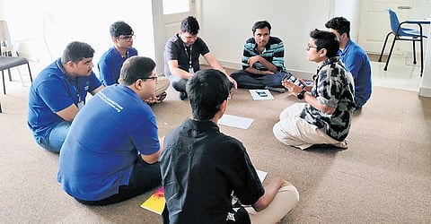 A group of people engaged in discussion at Akshadhaa Foundation