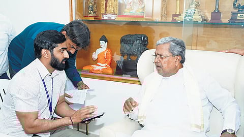 A socio-economic and educational survey enumerator collects details from CM Siddaramaiah at his residence ‘Cauvery’ in Bengaluru on Thursday