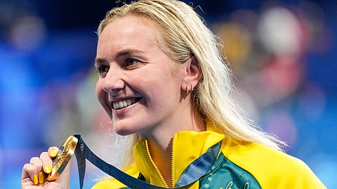 Australia's Ariarne Titmus poses with her gold medal after winning the women's 400-meter freestyle final at the 2024 Summer Olympics, Saturday, July 27, 2024, in Nanterre, France.