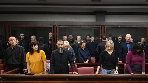 Lawyers of Ukrainian soldiers of the Aidar battalion captured by Russia during fighting in Ukraine stand in front of the defendants' cage during a hearing at the Southern District Military Court in Rostov-on-Don, Russia, Friday, Oct. 17, 2025.