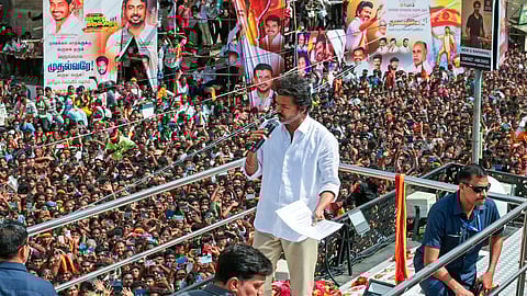 In this image from Sep. 27, 2025, Tamilaga Vettri Kazhagam chief and actor Vijay addresses a gathering before a stampede during a public event, in Karur.