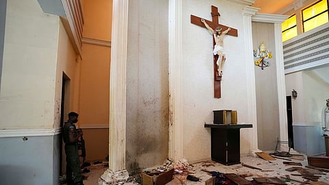 A police officer stands guard inside the St Francis Catholic Church, a day after an attack that targeted worshippers in Owo, Nigeria, on June 6, 2022.