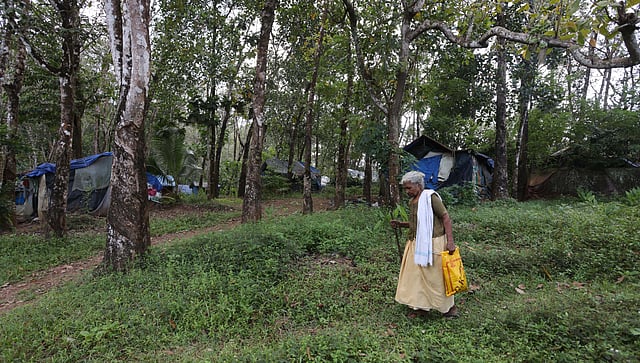 An elderly woman walks past the temporary sheds set up for families in the Arippa land struggle. Hundreds of families have been living here in abominable conditions without basic facilities.