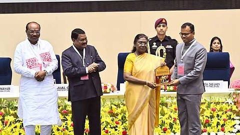 Mayurbhanj collector Hemakanta Say receiving the award from President Droupadi Murmu.
