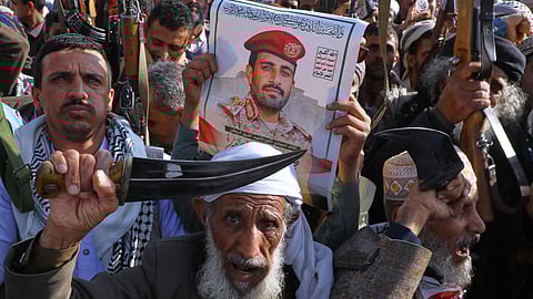 Houthi supporters hold a poster of Maj. Gen. Muhammad Abdul Karim al-Ghamari, who died of wounds he suffered after an Israeli attack, during an anti-U.S. and anti-Israel rally in Sanaa, Yemen, Friday, Oct. 17, 2025.