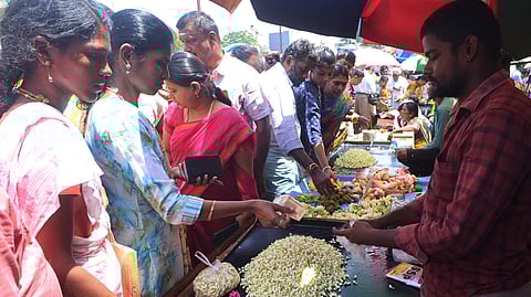 People are seen purchasing flowers inside the flower market at Mattuthavani in Madurai.