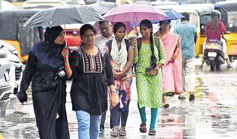 People seen walking in the rain on GST Road in Chrompet on Saturday.