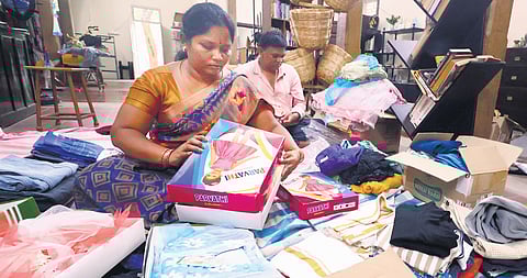 Kalpataru members segregate cardboard boxes and old clothes at the centre.